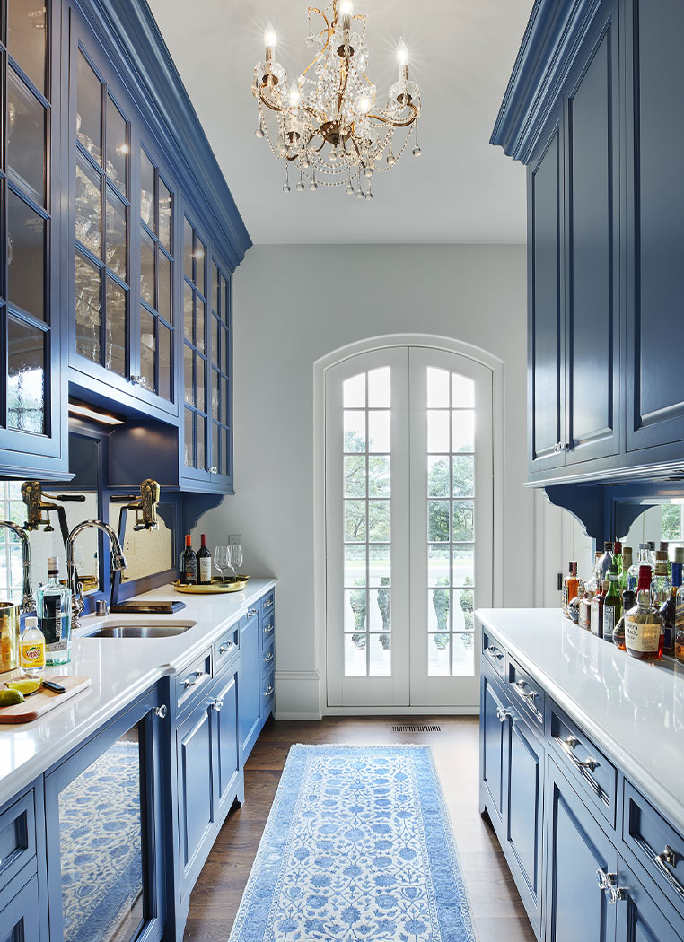 Blue Kitchen Galley With White Countertops