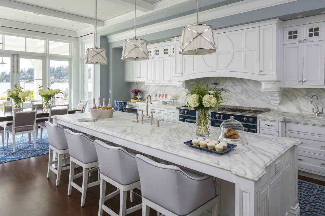 Kitchen With Large Island And Soft Gray Bar Stools